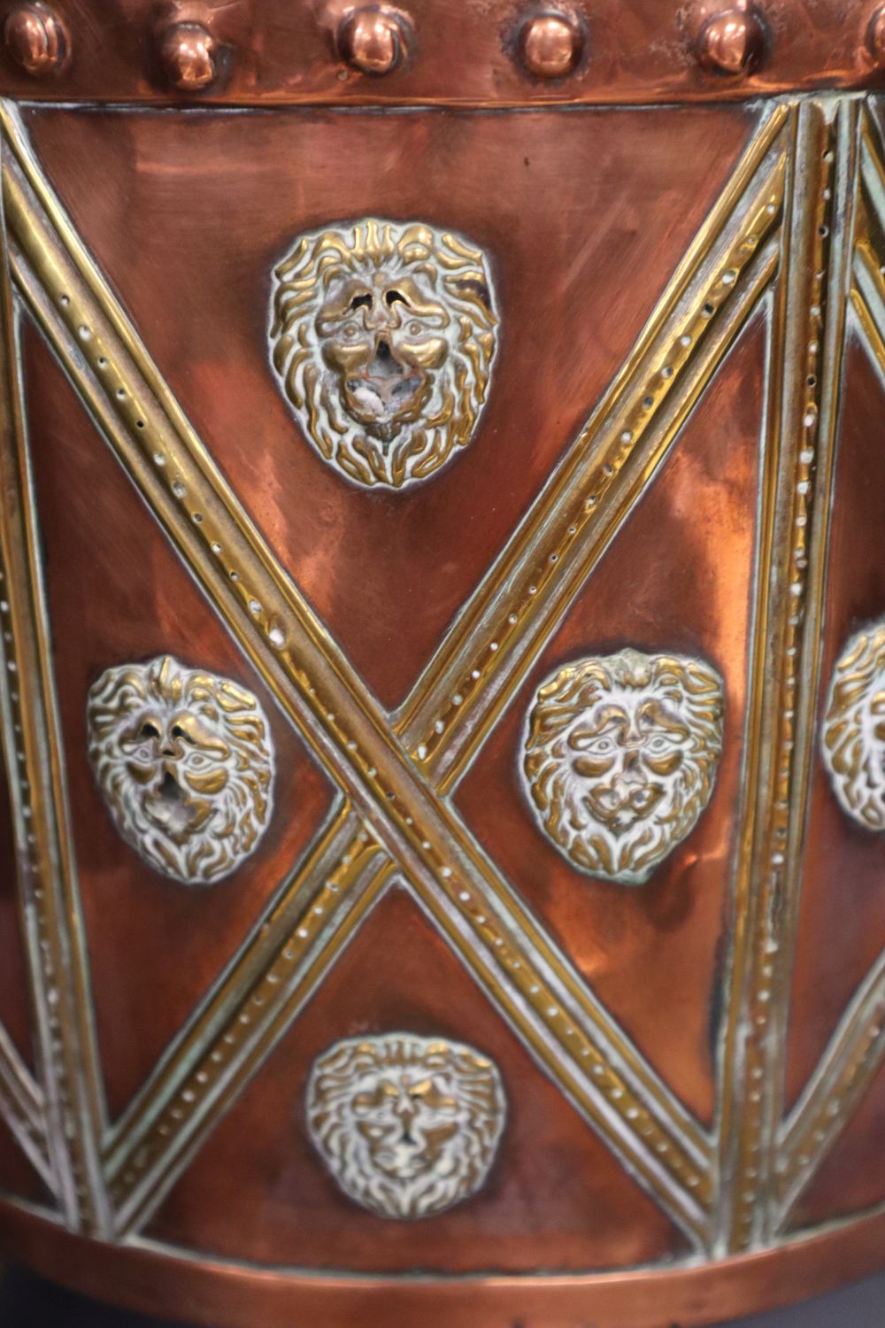 A Victorian copper and brass cylindrical coal box, with lion-mask ring handles, wood liner, 38cm